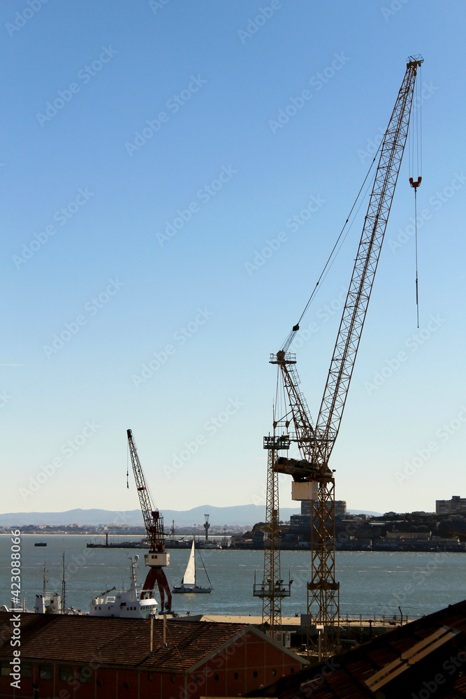 Cranes working on the dock by the Tagus river