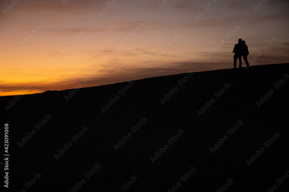 silhouette of a person on the top of mountain