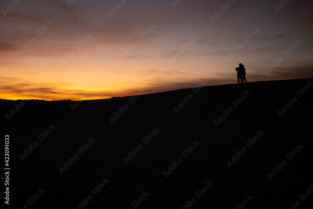 silhouette of a person on the top of the mountain