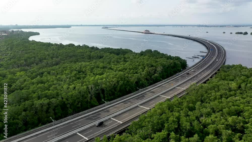 Mandara Toll Road above the Gulf of Benoa in Bali Indonesia with vehicle traffic, Aerial flyover shot Mandara Toll Road above the Gulf of Benoa in Bali Indonesia with vehicle traffic, Aerial flyover shot