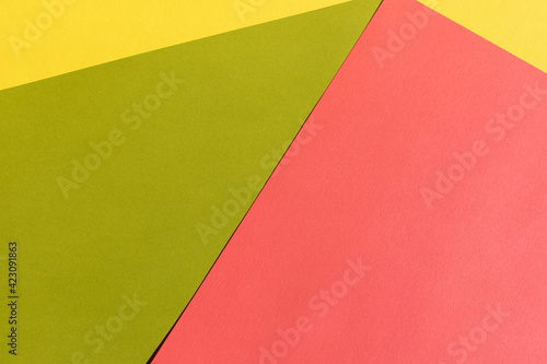 Abstract bright green, pink and yellow colored paper texture. Geometric shapes and lines. Minimalist background. Flat lay. Copy space.