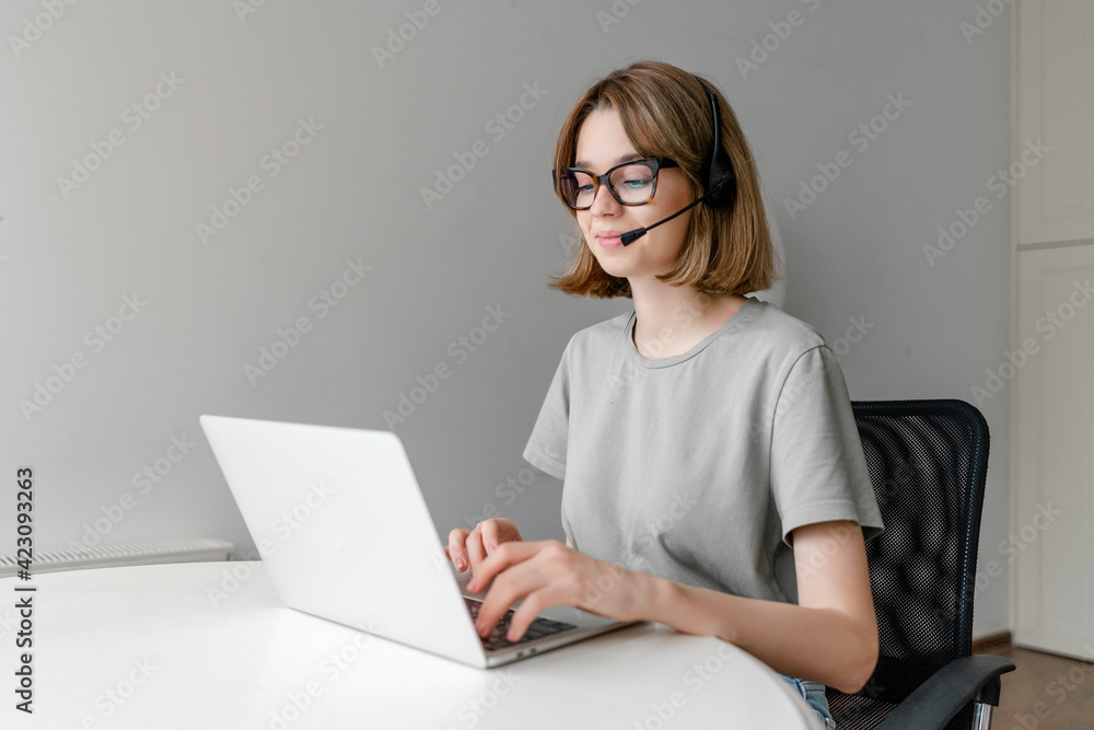 Smiling young happy female teacher tutor communicating by video conference call at home Smiling young happy female teacher tutor communicating by video conference call at home