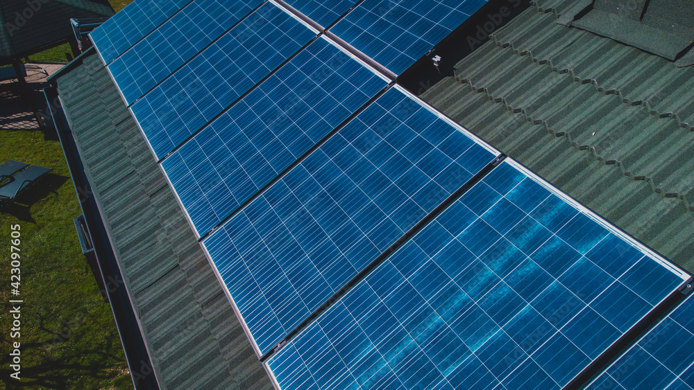 Photovoltaic sun power plant on the top of domestic house. Detail of solar panels for electricity on a house. Photovoltaic sun power plant on the top of domestic house. Detail of solar panels for electricity on a house.