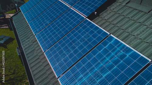 Photovoltaic sun power plant on the top of domestic house. Detail of solar panels for electricity on a house.