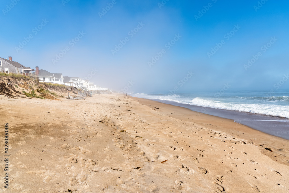 Beautiful sandy beach along the coast of New Hampshire on a foggy autumn morning Beautiful sandy beach along the coast of New Hampshire on a foggy autumn morning