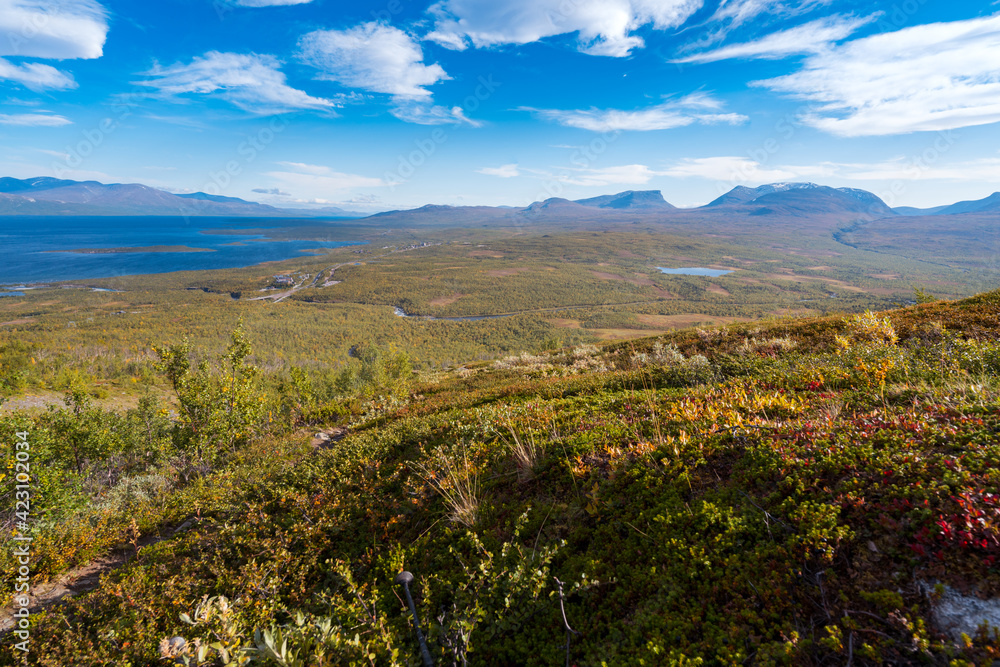 Lapponian gate, famous mountain pass in the Swedish arctic in beautiful autumn colors on a sunny day. Viewed from Nuolja, Njulla mountain. Hiking in Abisko national park, Kiruna, Sweden.