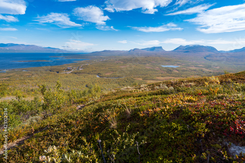 Lapponian gate, famous mountain pass in the Swedish arctic in beautiful autumn colors on a sunny day. Viewed from Nuolja, Njulla mountain. Hiking in Abisko national park, Kiruna, Sweden.