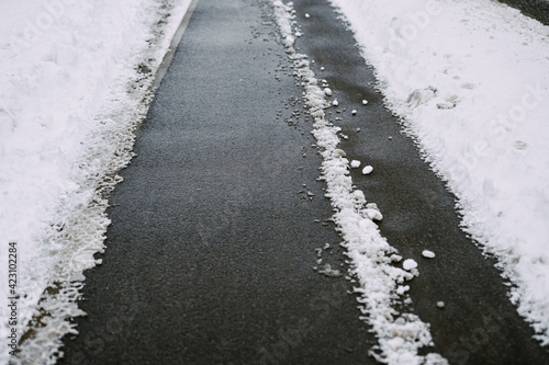 sidewalk cleared of snow in winter