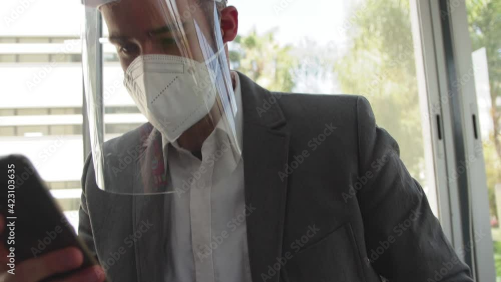Hombre utiliza mascarilla y careta en oficina prevencio pandemia
