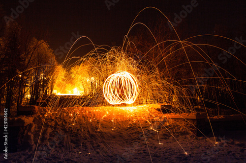 Fire painting at snow winter at night