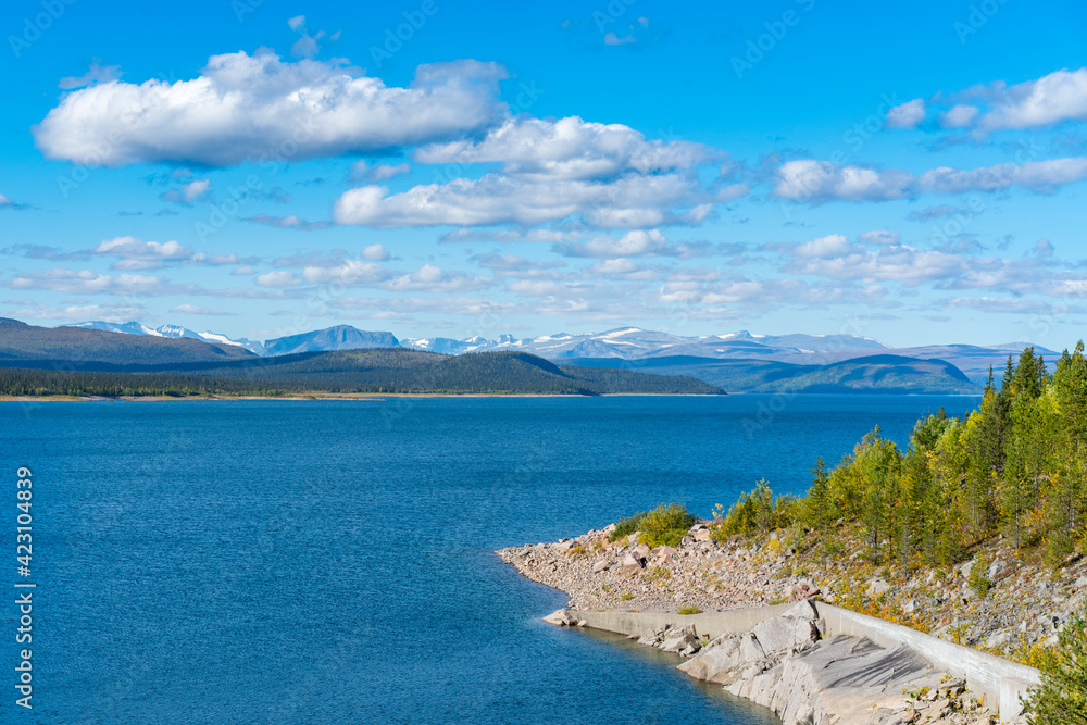 Tjaktjajavrre, lake in Sweidish Lapland on a beautiful day of arctic summer. Mountains of Sarek national park in the distance. Beautiful landscape of european arctic. Jokkmokk municipality.