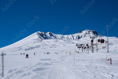 ERCIYES, TURKEY - FEBRUARY 2021: View of the ski slopes and chair lifts at Mount Erciyes ski area, February 2021, in Kayseri, Turkey. Mount Erciyes ski area is one of the longest slope in Turkey photo
