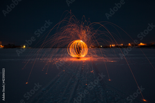Fire painting at snow winter at night
