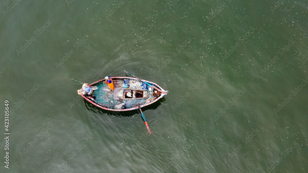 Top view, aerial view wooden fishing boat on the beach from a drone.