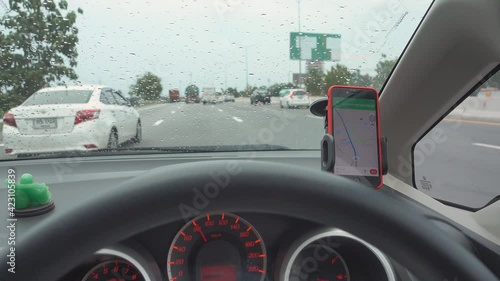 The map gps navigation on modern smartphone device gadget mounted on phone holder in car dashboard doing driving on the expressway go to destination 
