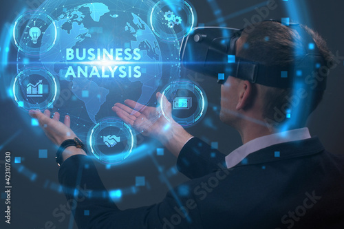 Business, Technology, Internet and network concept. Young businessman working on a virtual screen of the future and sees the inscription: Business analysis