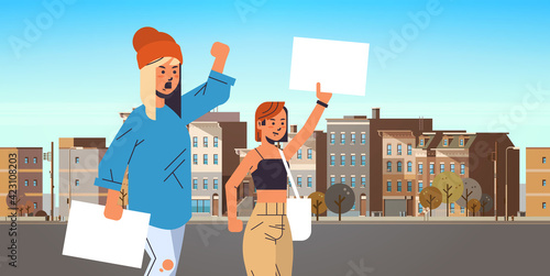 activists couple holding blank placards feminist demonstration girl power movement rights protection women empowerment concept portrait cityscape background horizontal