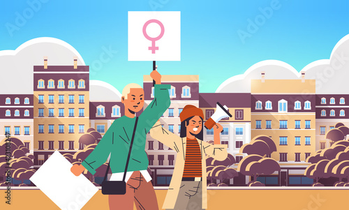 activists couple holding placards with female gender sign using loudspeaker feminist demonstration girl power movement rights protection women empowerment concept portrait cityscape horizontal