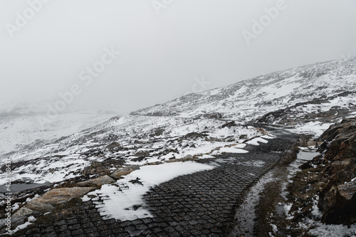 The winding, snow-covered path on the Kosciuszko Summit Walk in Kosciuszko National Park.