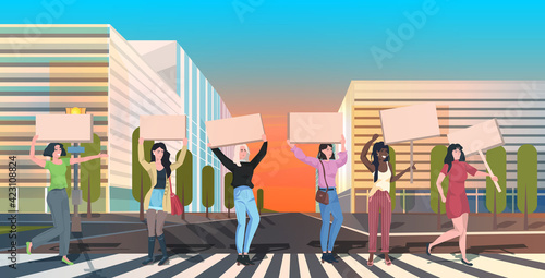 mix race activists protesting holding blank placards feminist demonstration girl power movement rights protection women empowerment concept cityscape background full length horizontal