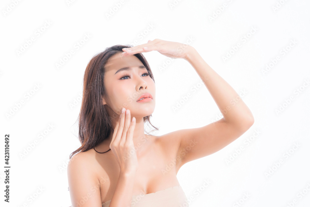 Beautiful young woman with clean fresh skin, Hair sleek, Proposing a product. Gestures for advertisement on gray background, Front view, with copy space. Beautiful young woman with clean fresh skin, Hair sleek, Proposing a product. Gestures for advertisement on gray background, Front view, with copy space.