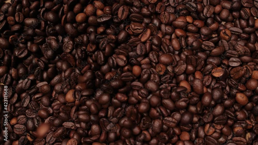 Coffee beans falling in slow motion on a table - food photography Coffee beans falling in slow motion on a table - food photography