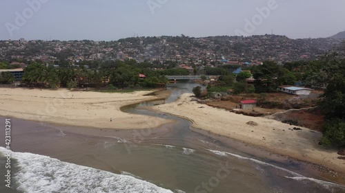 Aerial river into Atlantic Ocean Freetown Sierra  Leone. Sierra Leone on the coast of west Africa is a nation that suffers with extreme poverty and hunger. Tropical climate environment. photo