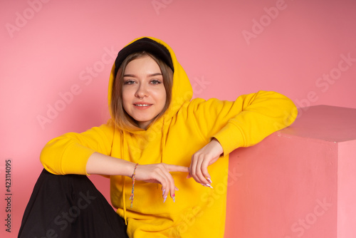Girl in yellow hoodie and black cap © vkfoto
