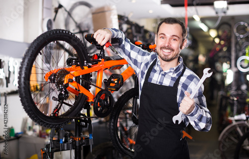 Bilde på lerret Racer is working on master bicycle assembly in sports workshop.