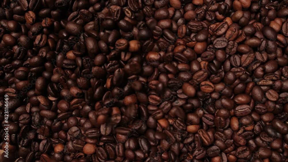 Coffee beans falling in slow motion on a table - food photography Coffee beans falling in slow motion on a table - food photography