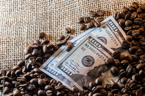US dollars and roasted coffee beans on jute background in Brazil