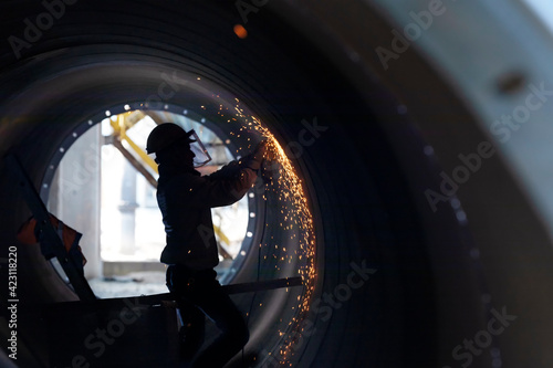 Welder is grinding the welding of large pipe. Grinding is an abrasive machining process that uses a grinding wheel as the cutting tool. Milling practice is a large and diverse area of manufacturing.