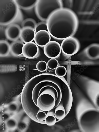 Photography Multi size pvc pipe on the metal rack in black and white