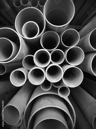 Multi size pvc pipe on the metal rack in black and white