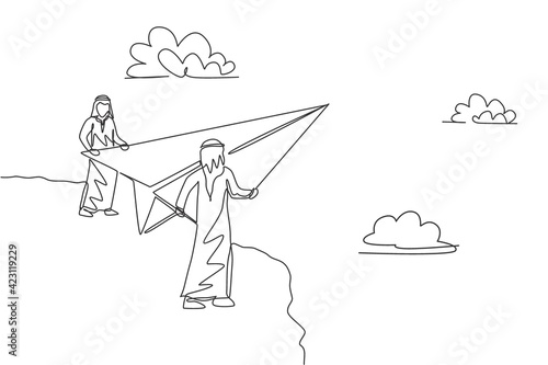 Continuous one line drawing two young Arab male workers fly paper plane from top of mountain. Success business managers minimalist metaphor concept. Single line draw design vector graphic illustration