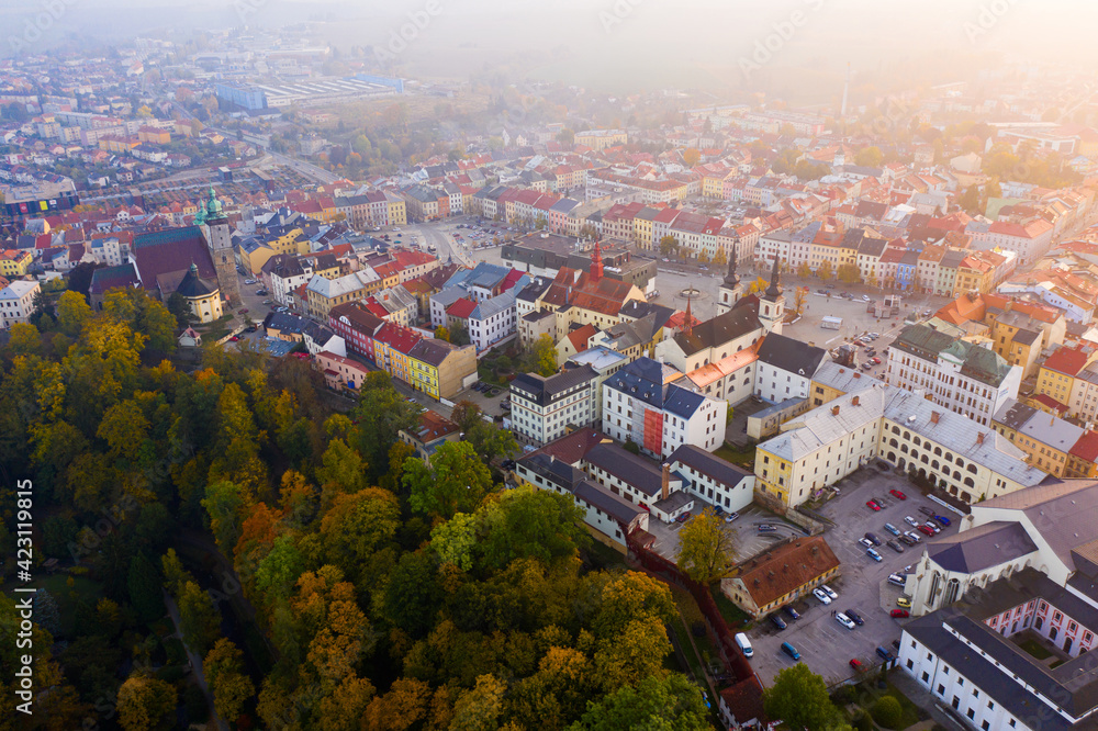 Scenic aerial view of historical centre of Jihlava in autumn gauze overlooking belfries of St. James and St. Ignatius churches and red steeple of Town Hall, Czech Republic..