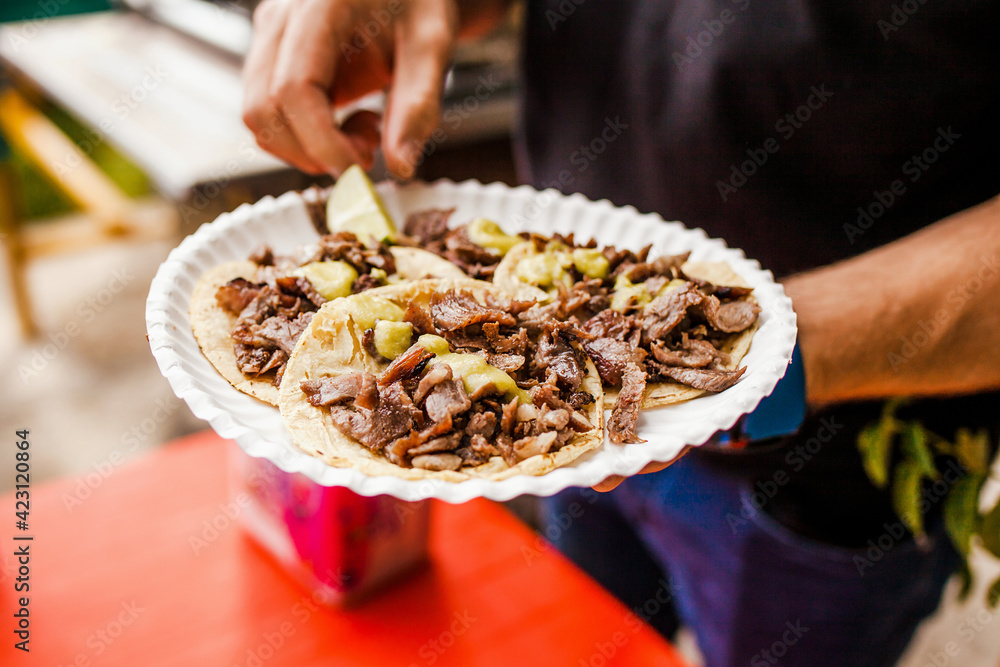 cooking Mexican tacos with beef, traditional street food in Mexico city cooking Mexican tacos with beef, traditional street food in Mexico city