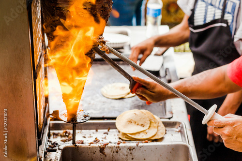 cooking Mexican tacos with beef, traditional street food in Mexico city photo