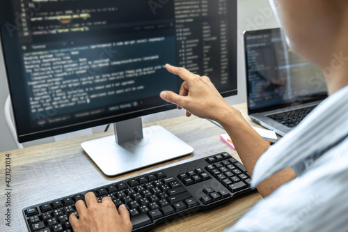 Programmer Team of Developing programming and website working in a software develop company office, writing codes and typing data code, Programming with HTML, PHP and javascript