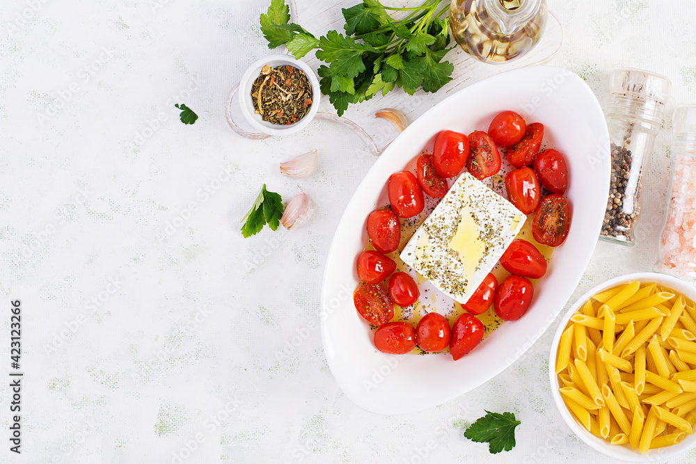 Preparation of ingredients for fetapasta. Trending Feta bake pasta recipe made of cherry tomatoes, feta cheese, garlic and herbs. Top view, above, copy space. Preparation of ingredients for fetapasta. Trending Feta bake pasta recipe made of cherry tomatoes, feta cheese, garlic and herbs. Top view, above, copy space.