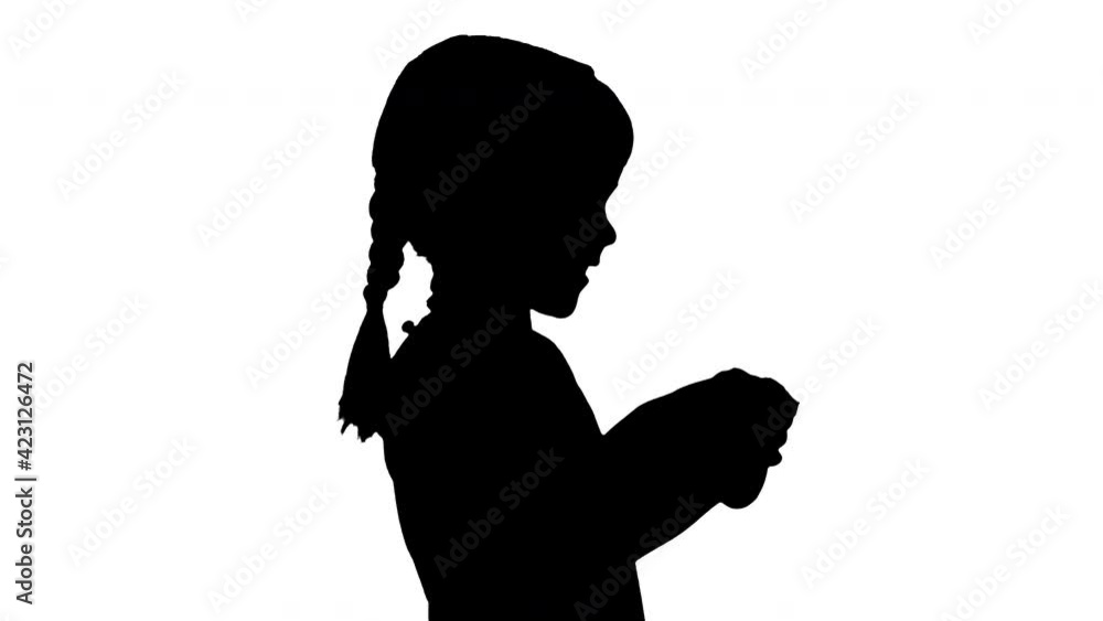 Silhouette Excited little girl play videogame holding joystick in her hands. Silhouette Excited little girl play videogame holding joystick in her hands.