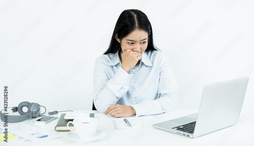 Working Asian women feel stressed, dismal tired from work, migraine headaches from hard work while working at the office Working Asian women feel stressed, dismal tired from work, migraine headaches from hard work while working at the office