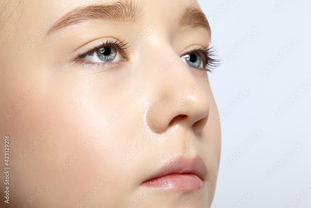 Closeup shot of human teenager girl face. Young female with natural face and eyes beauty makeup Closeup shot of human teenager girl face. Young female with natural face and eyes beauty makeup