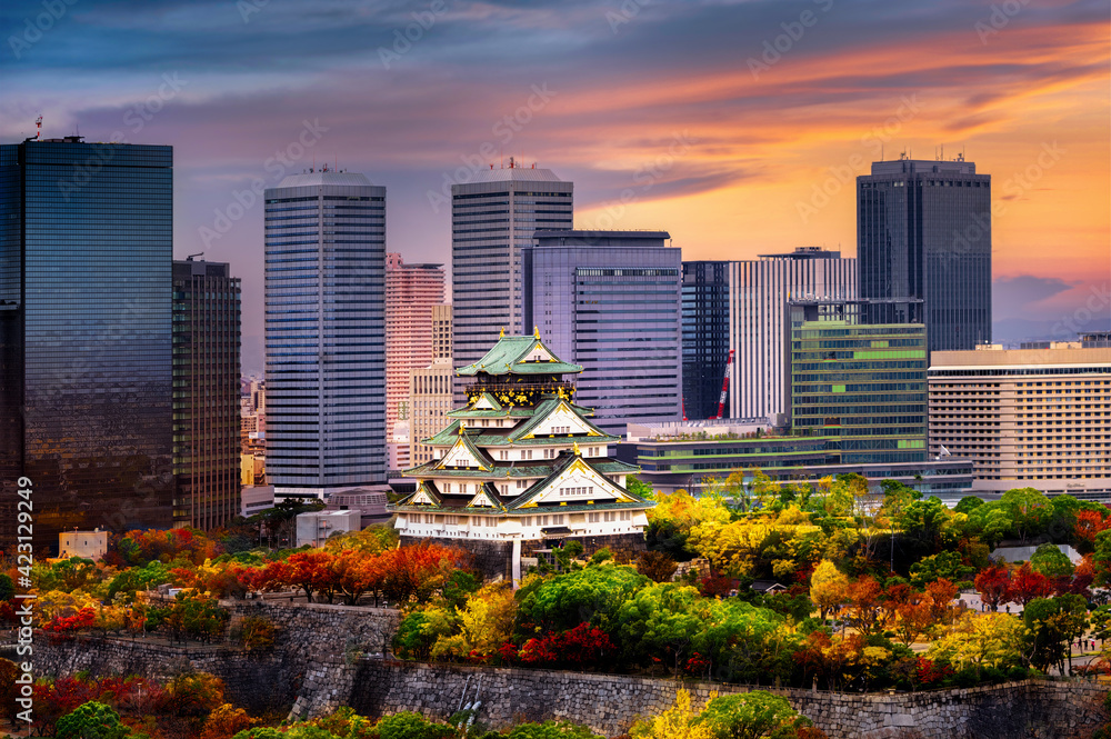 Fototapeta premium Osaka castle stay in the middle of the develops city in the season change of autumn, upcoming sport event in Japan, visit and travel in Japan, Sport Event, Travel Japan