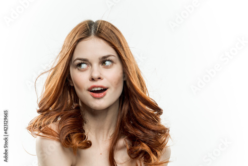 attractive red-haired woman with bare shoulders glamor cosmetics model