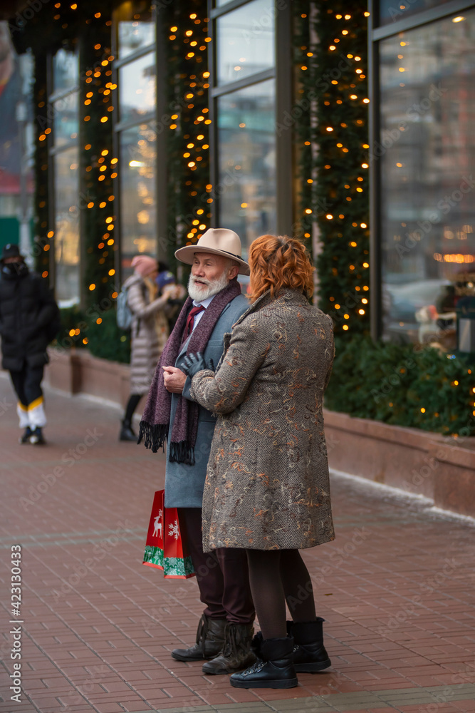 an elderly couple walking the streets of the city
