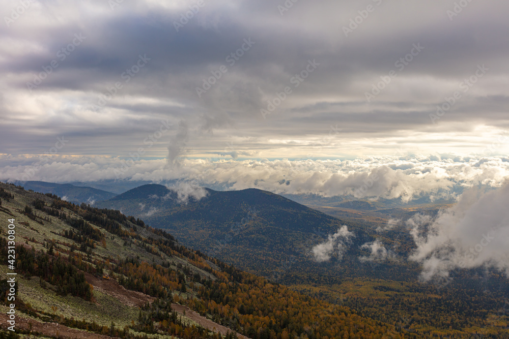 autumn in the mountains. view of a mountain valley with beautiful clouds, fog and a small lake-reflecting the sky. very high quality photos
