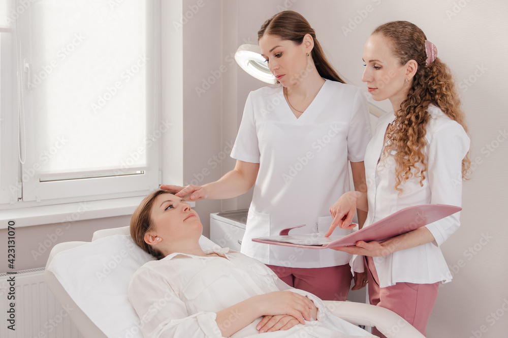 Fototapeta premium Two doctors examining a patient