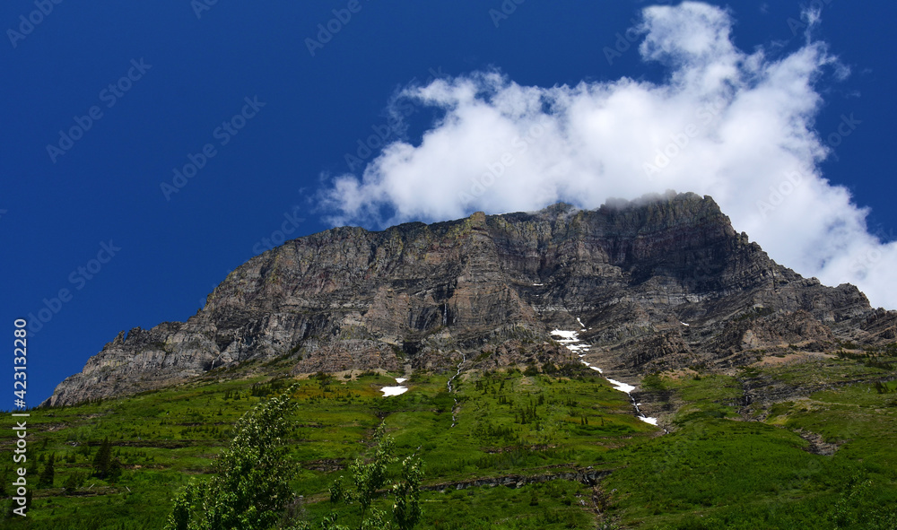 scenic view from siyeh bend of  mountinis and forested hillside  in early summer along the going-to-the-sun road in glacier national park, montana