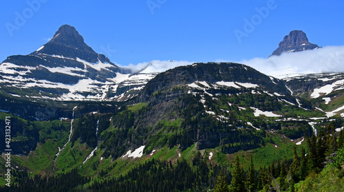 spectacular reynolds and clements mountains, waterfalls, and glacial valley  in early summer along the going-to-the-sun road in glacier national park, montana © Nina